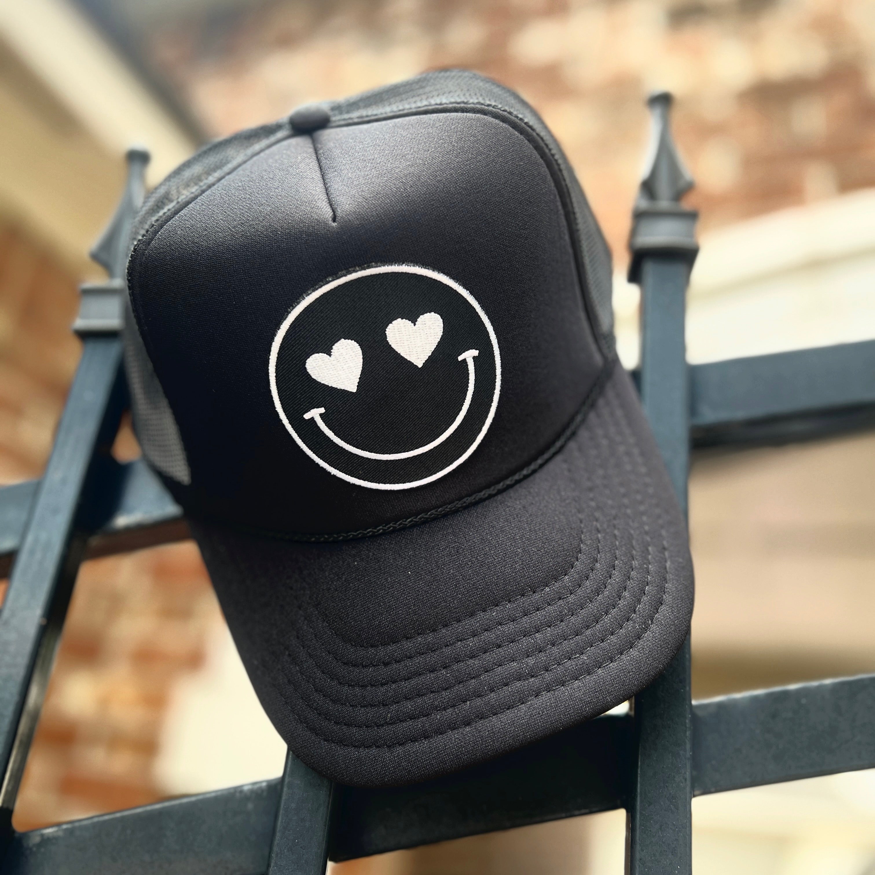 Build Your Own Black Happy Heart Trucker Hat by Confettees